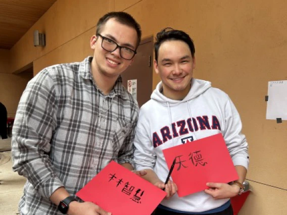 students showing their calligraphy samples