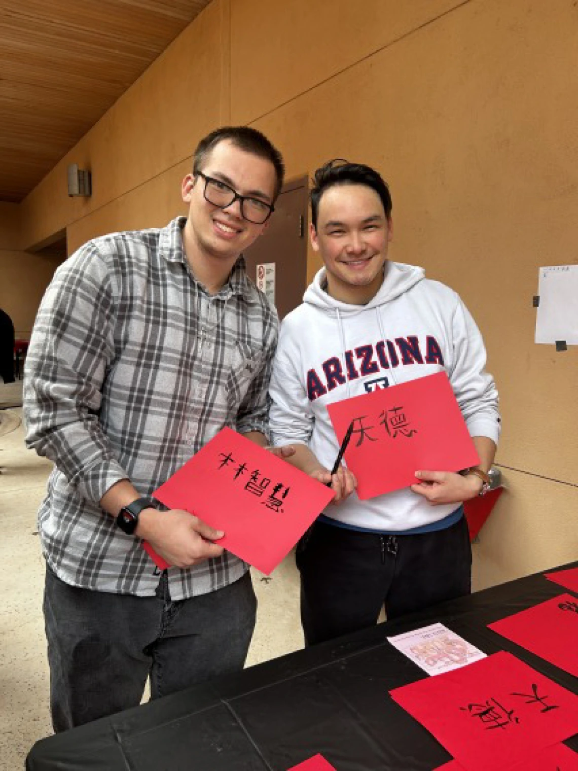 students showing their calligraphy samples